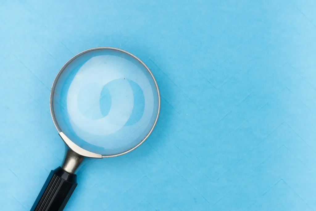 Magnifying glass representing due diligence during AML checks for accounting practices
