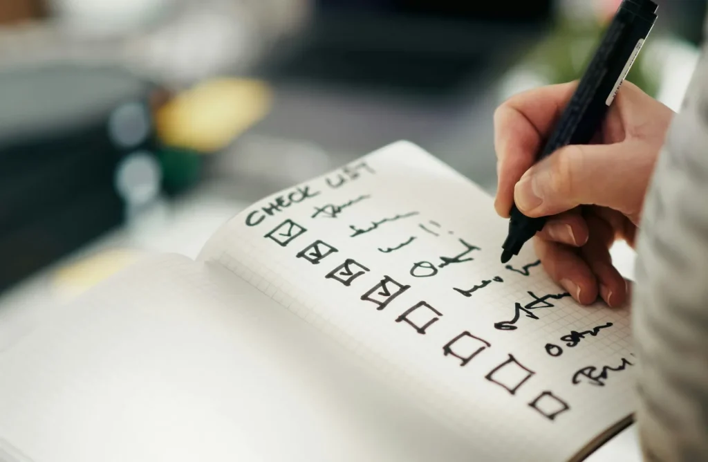Person checking items off a client onboarding checklist for a UK accounting firm